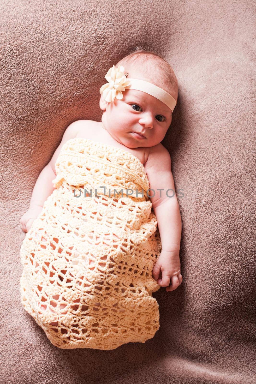 Newborn baby girl on the crochet blanket