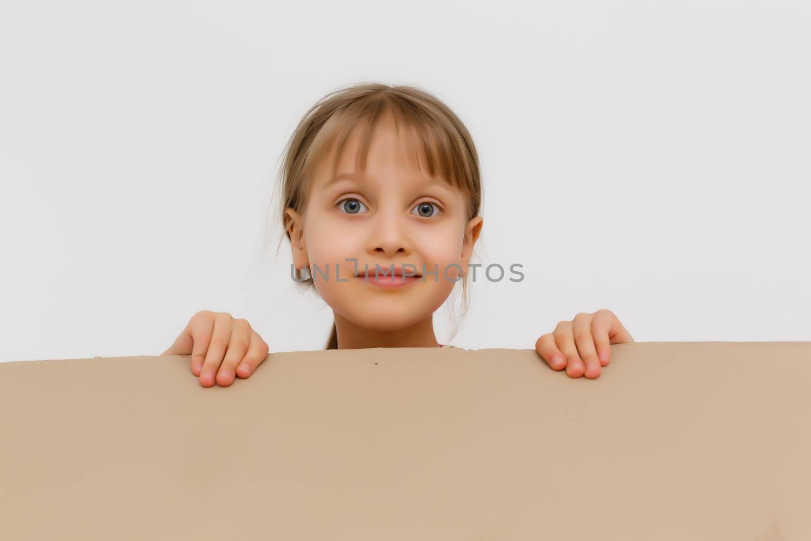 Cute little girl standing in large cardboard box, wanting to play hide-and-seek by Andelov13