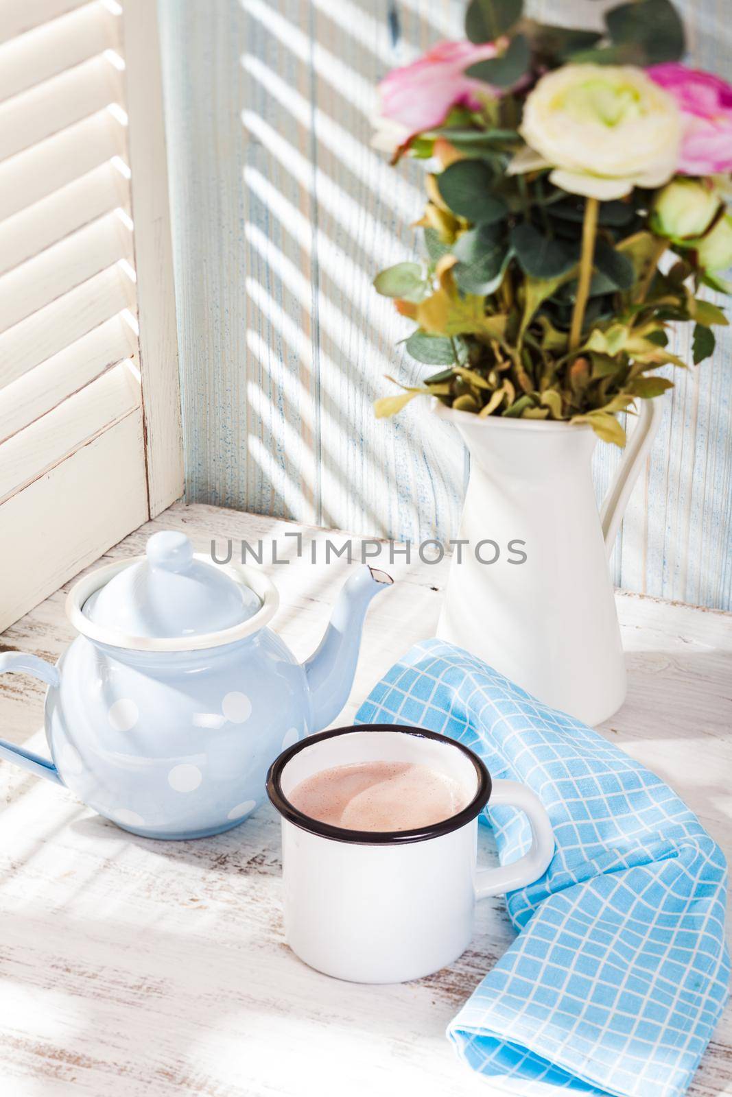 Morning cocoa cup on the kitchen table in shabby chic style