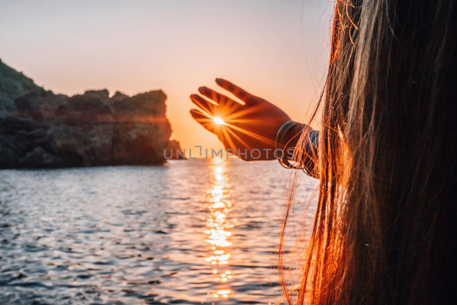 woman traveler drinks coffee with a view of the mountain landscape. A young tourist woman drinks a hot drink from a cup and enjoys the scenery in the mountains. Trekking concept