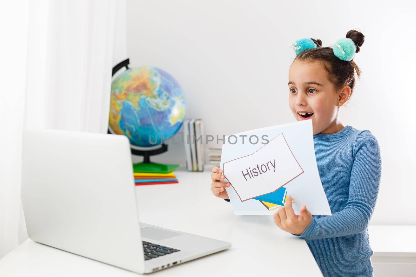 little girl learning history on laptop online by Andelov13