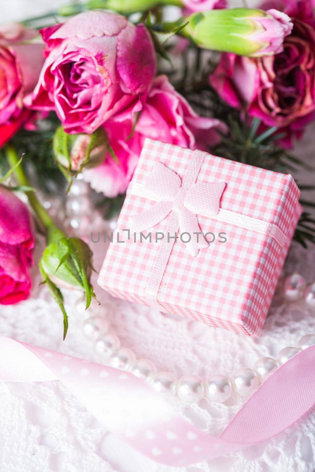 Pink box with little present and flowers