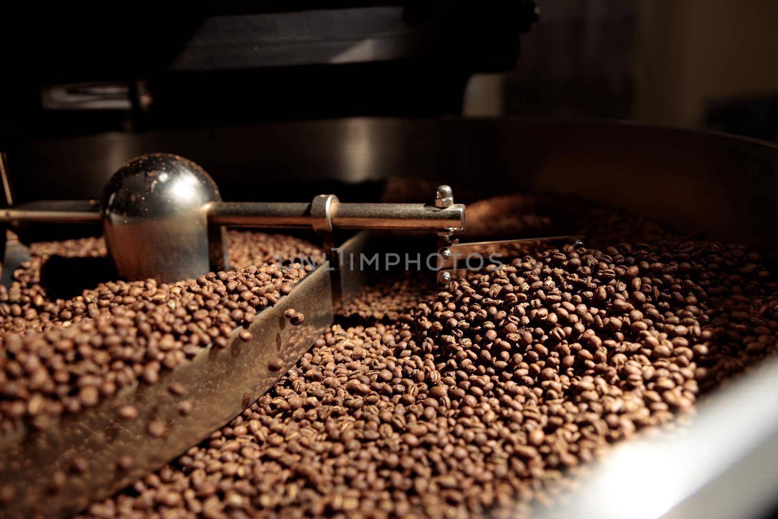 Coffee processing. Roastery, roasting machine and fresh beans