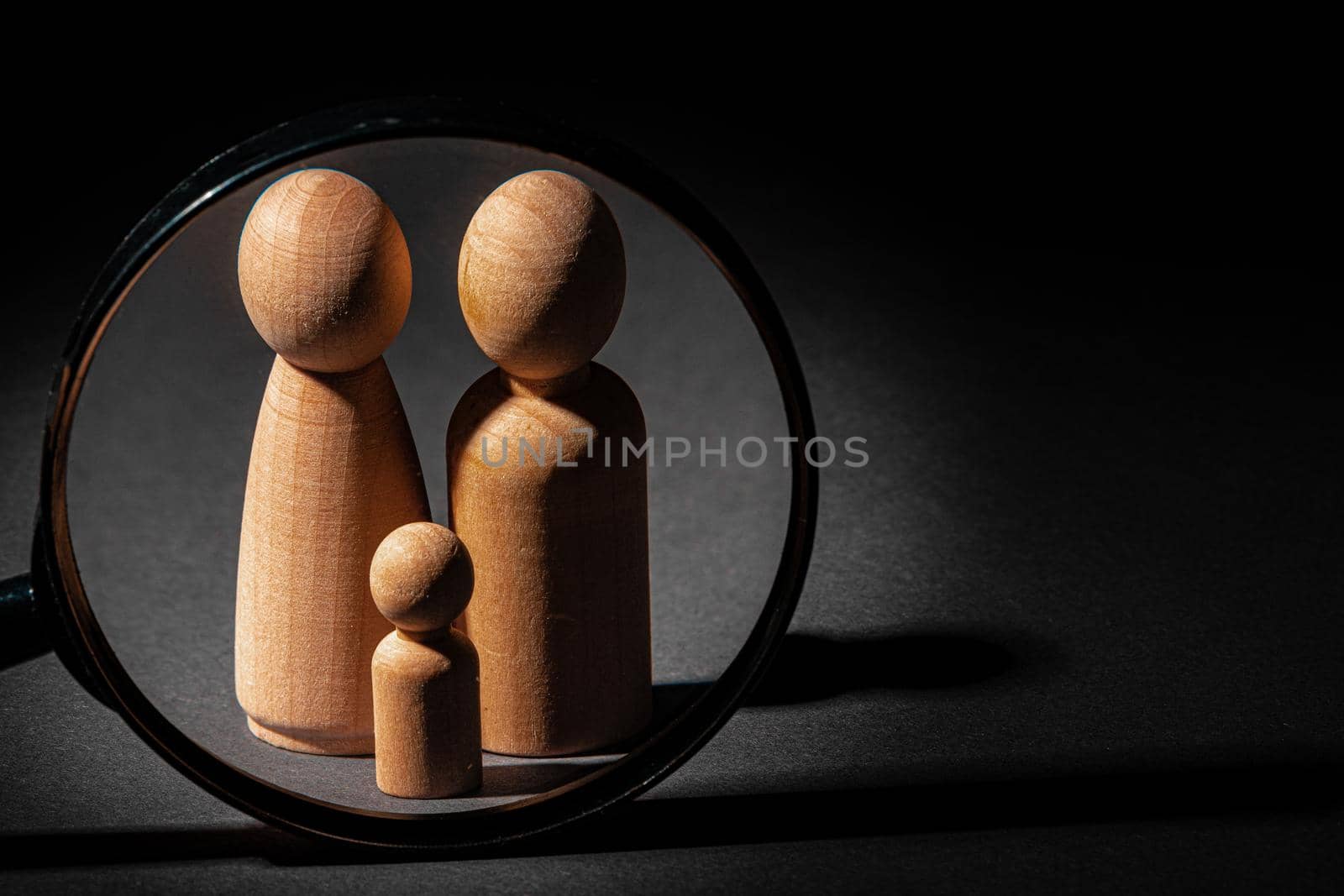 Wooden little figures of people close up. Family concept