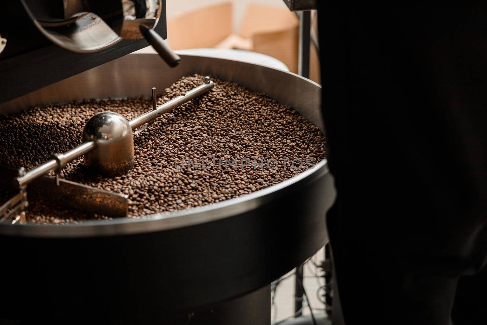 Coffee processing. Roastery, roasting machine and fresh beans