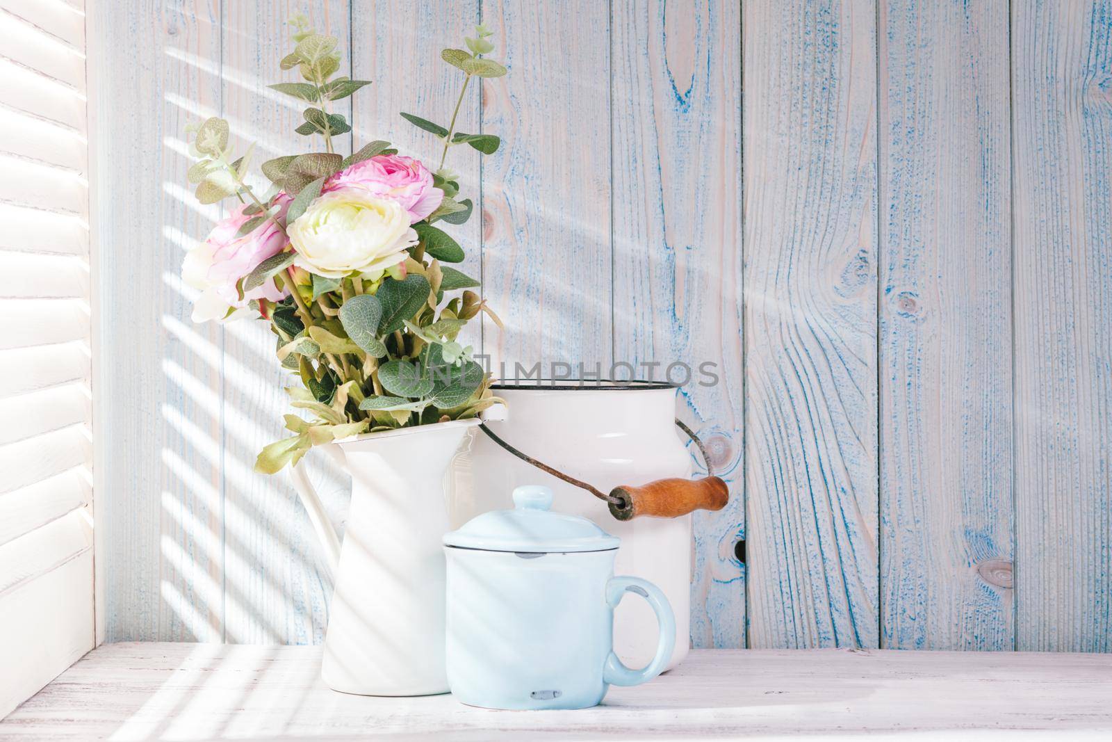 Morning still life on shabby chic table and light from the blinds