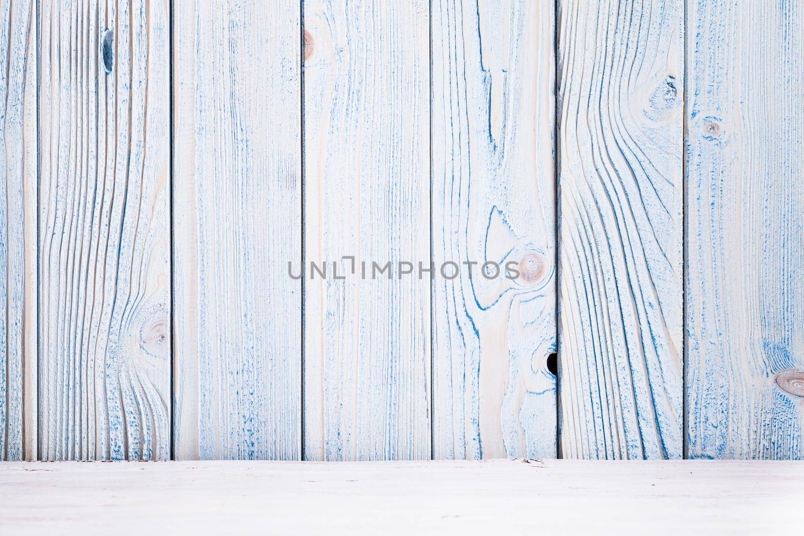 Blue wooden wall, painted in shabby chic style and white floor