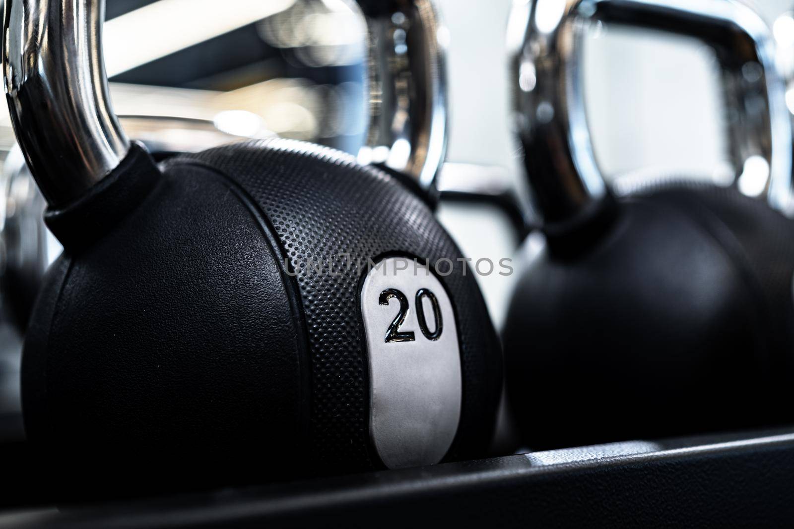 Close up photo of new dumbbells on a rack in a gym