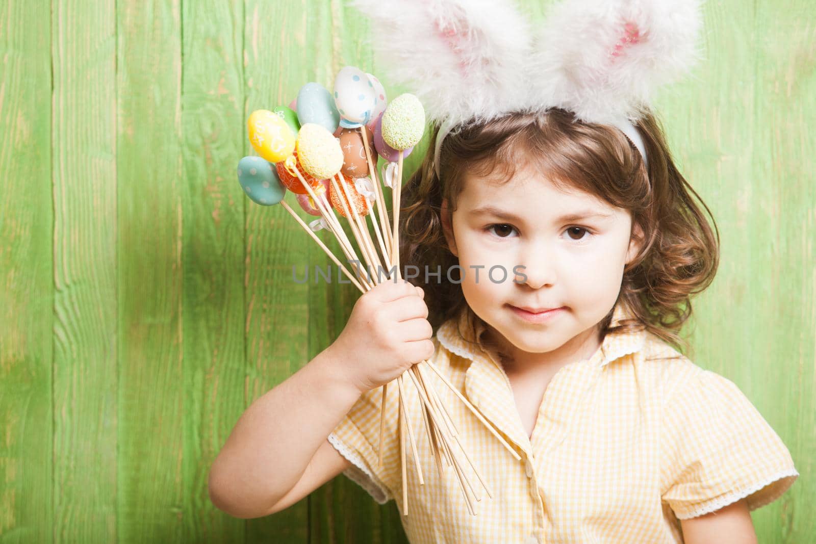 Girl with bunny ears and little eggs. Easter celebration