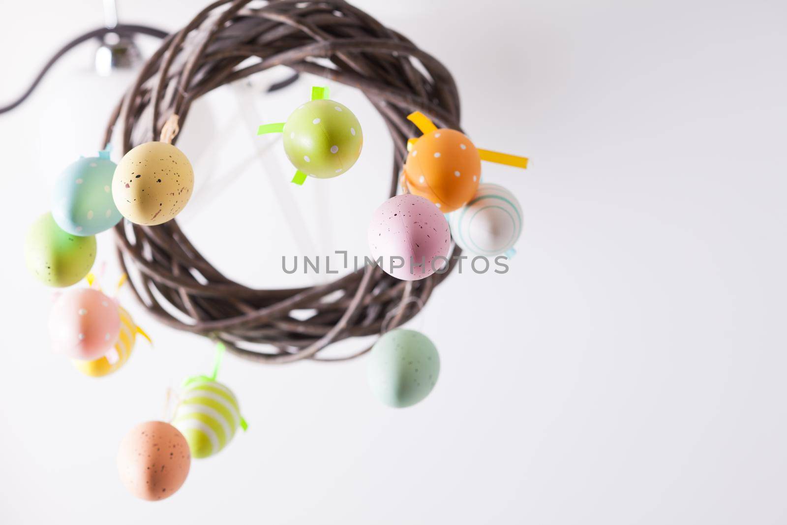 Easter wreath with color eggs on ribbons