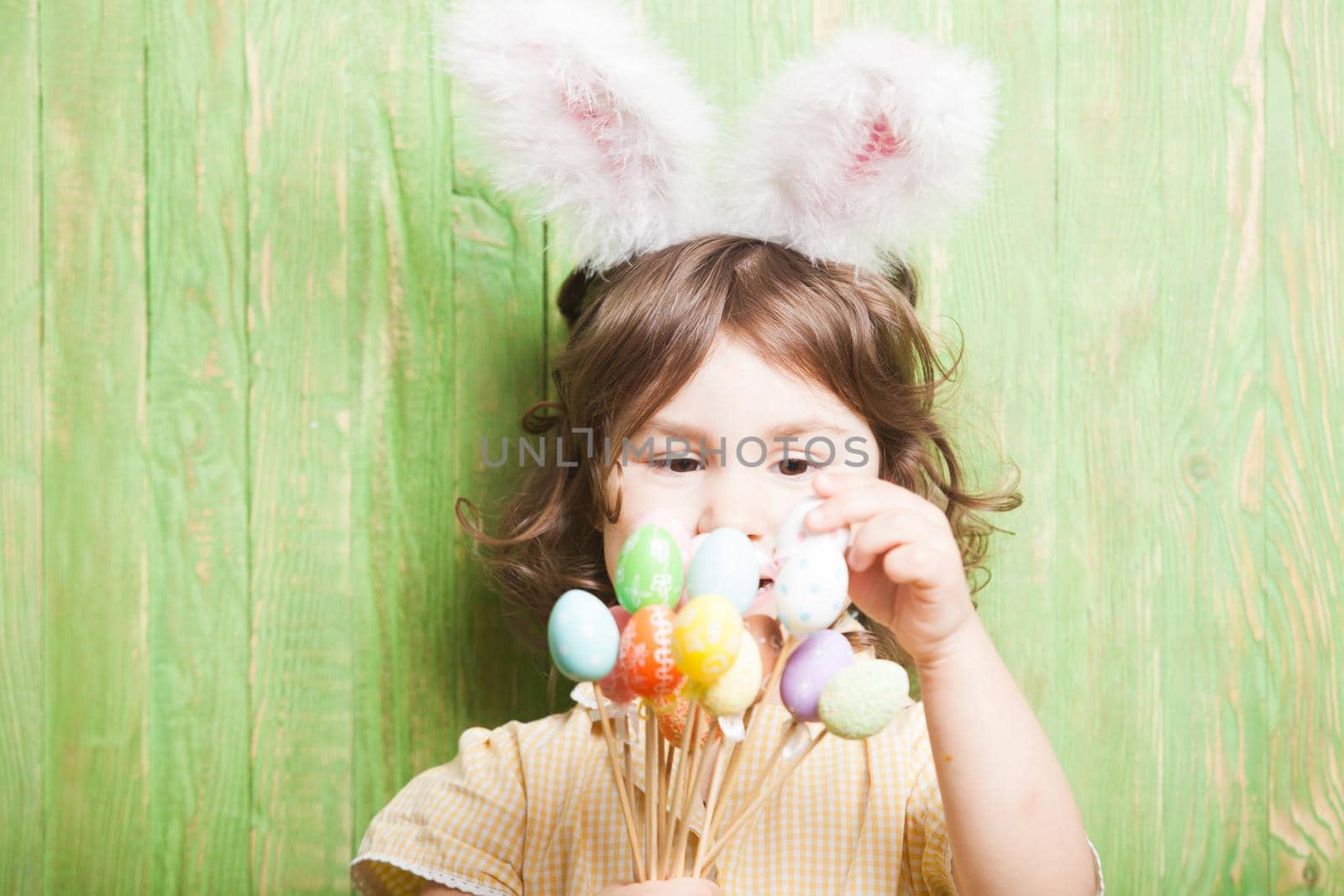 Girl with bunny ears and little eggs. Easter celebration