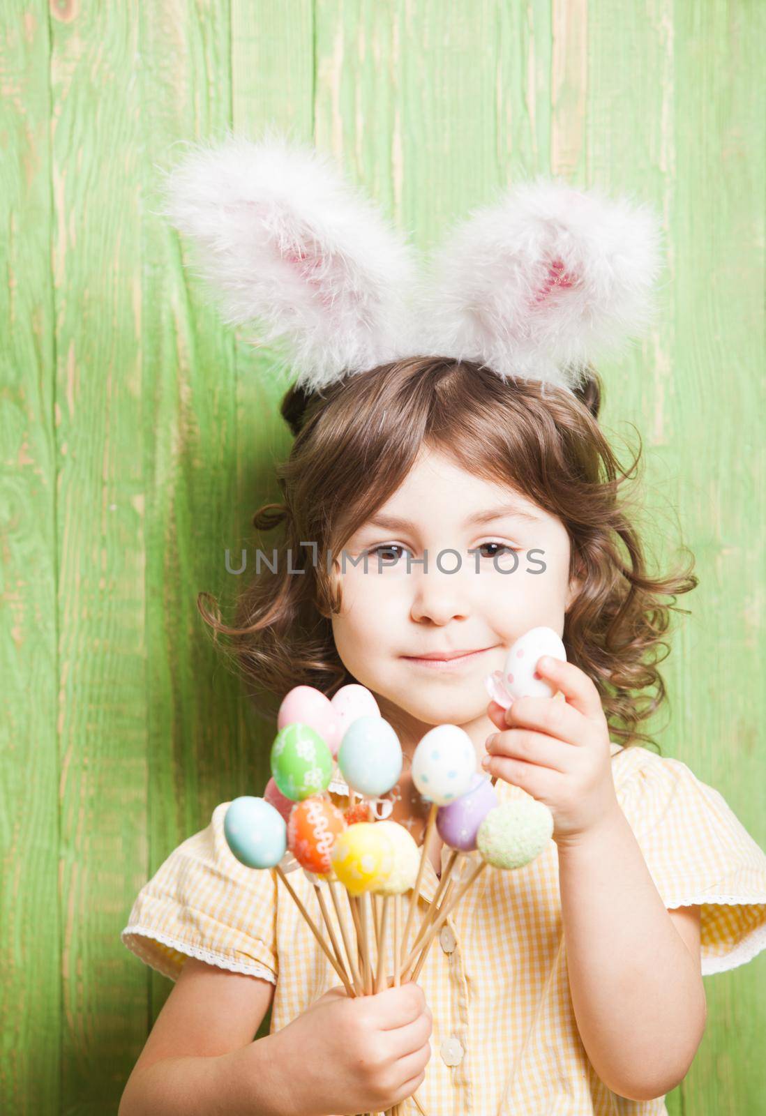 Girl with bunny ears and little eggs. Easter celebration