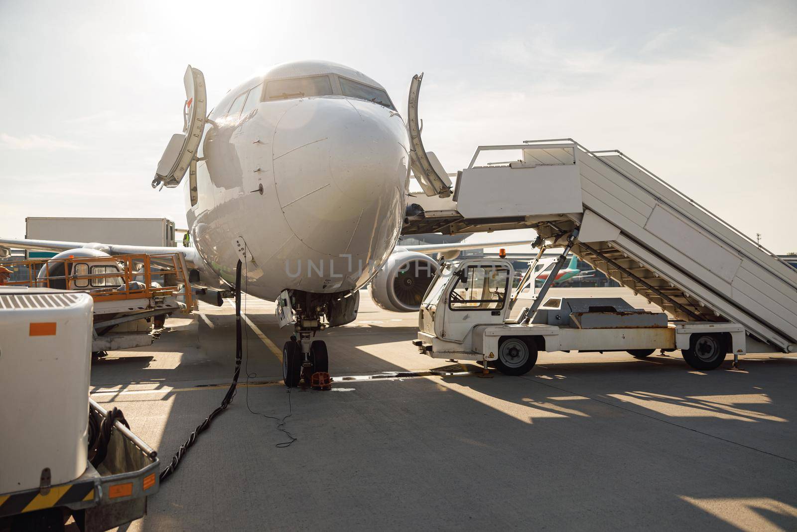 Details of modern airplane during refueling at airport outdoors on a daytime. Aircraft by Yaroslav_astakhov