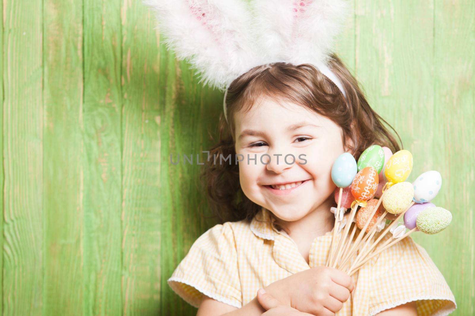 Girl with bunny ears and little eggs. Easter celebration