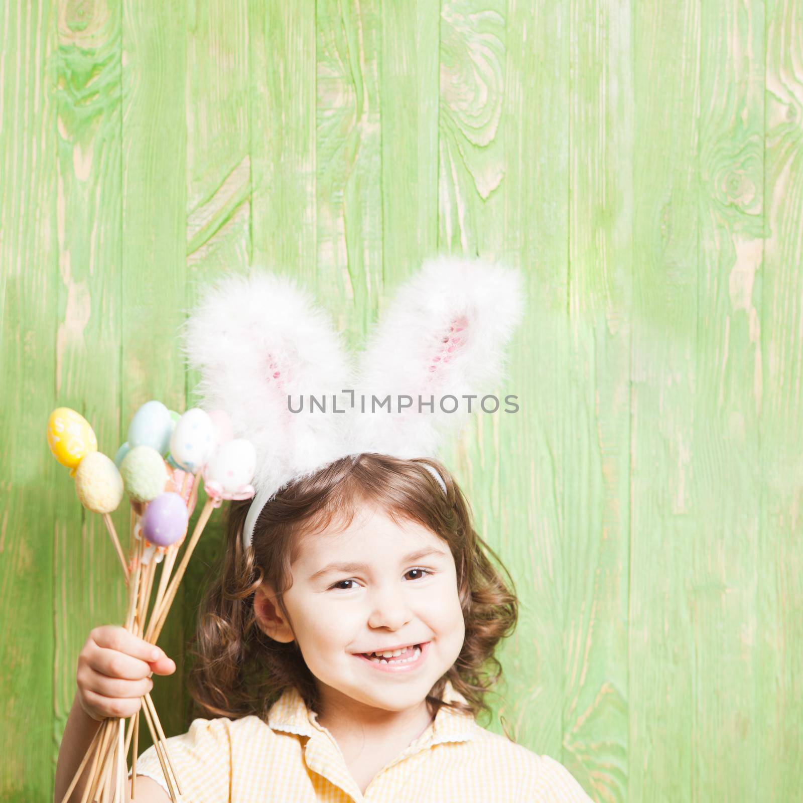 Girl with bunny ears and little eggs. Easter celebration
