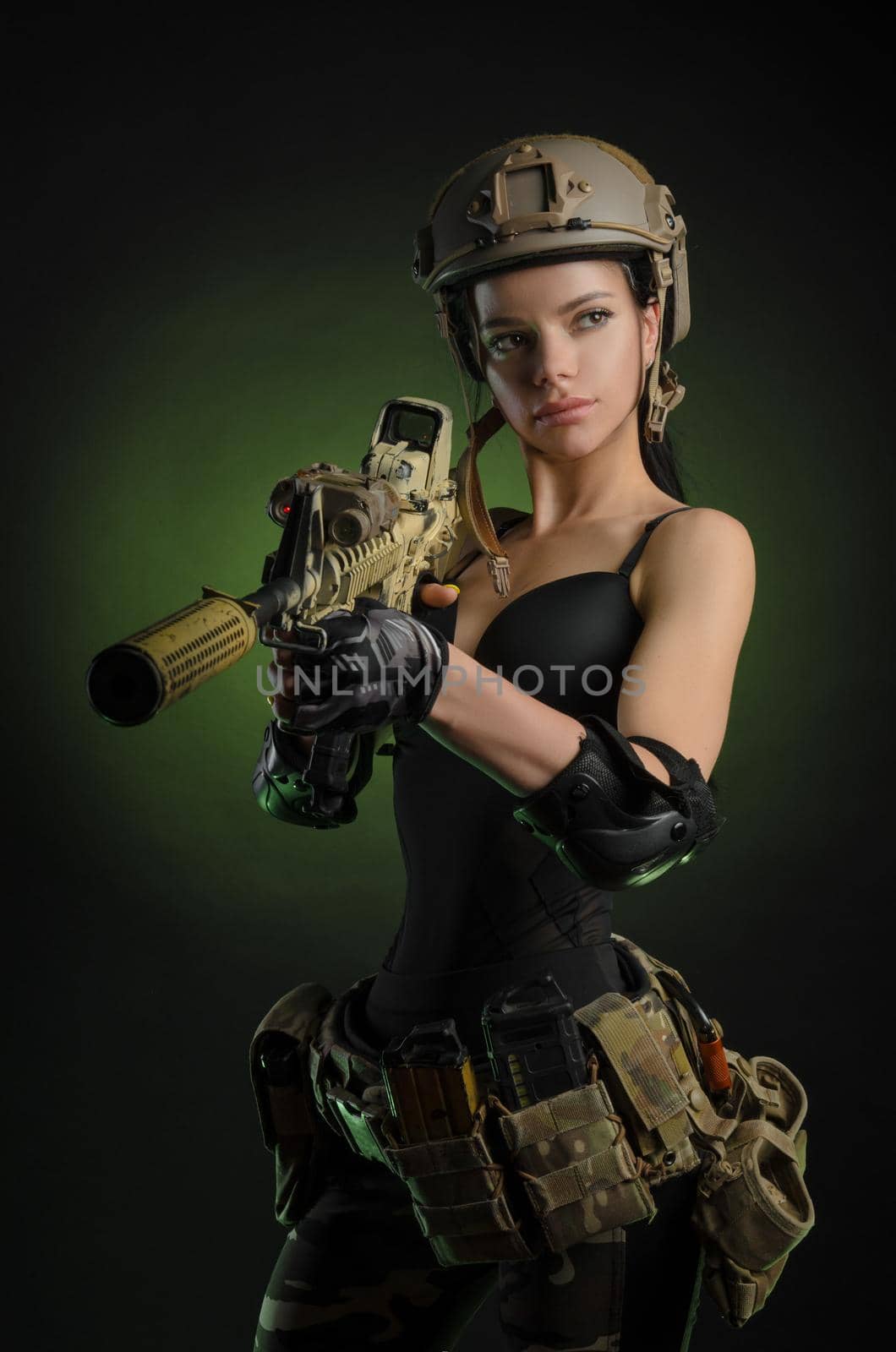 the girl in military special clothes posing with a gun in his hands on a dark background in the haze by Rotozey