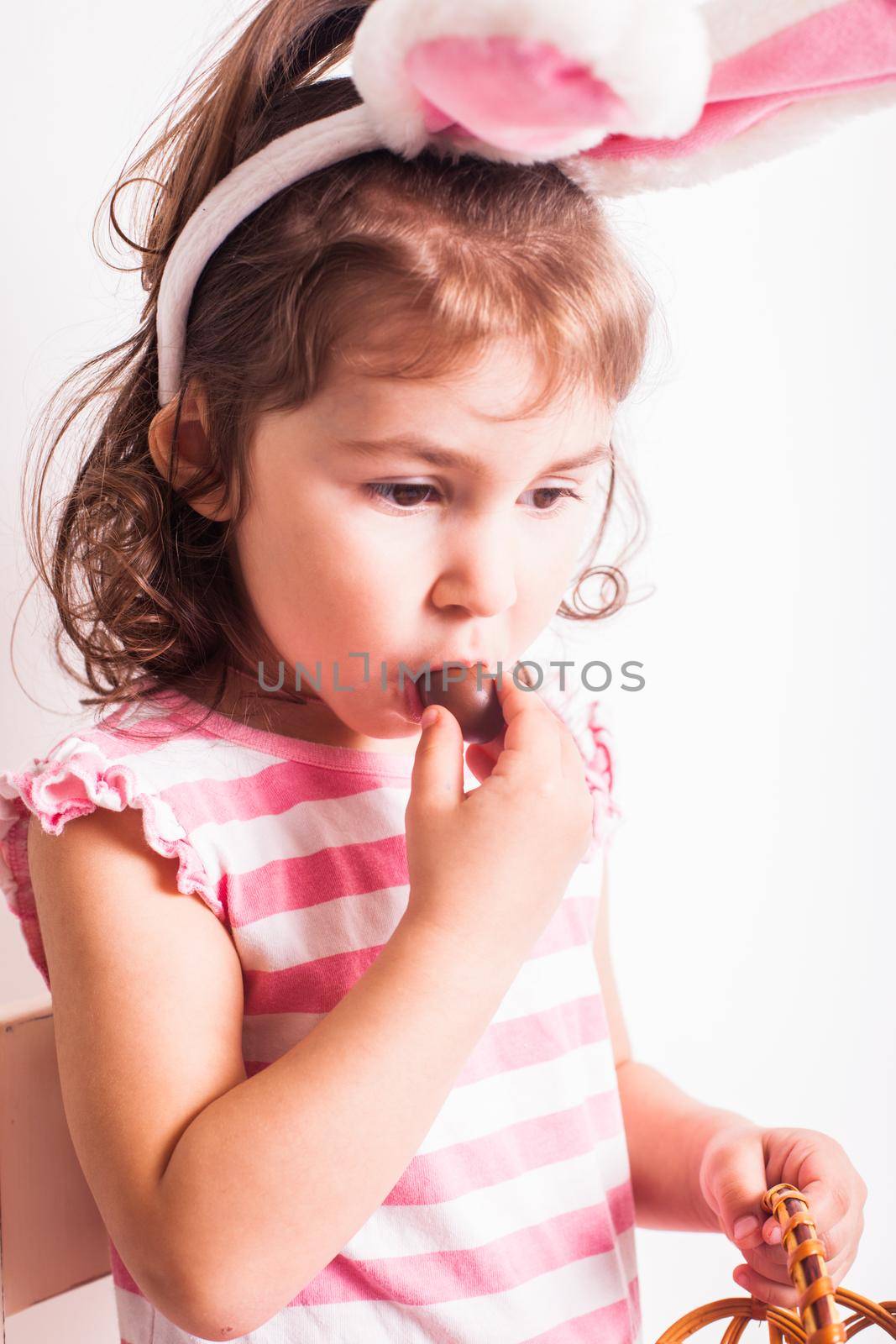Girl eats a chocolate eggs by oksix