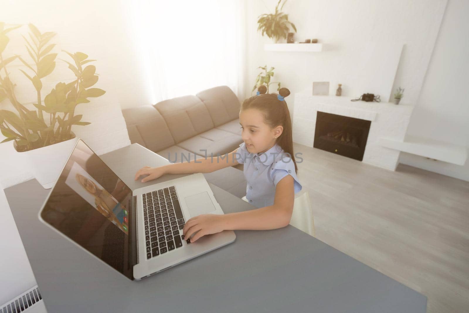 little girl studying with laptop online learning