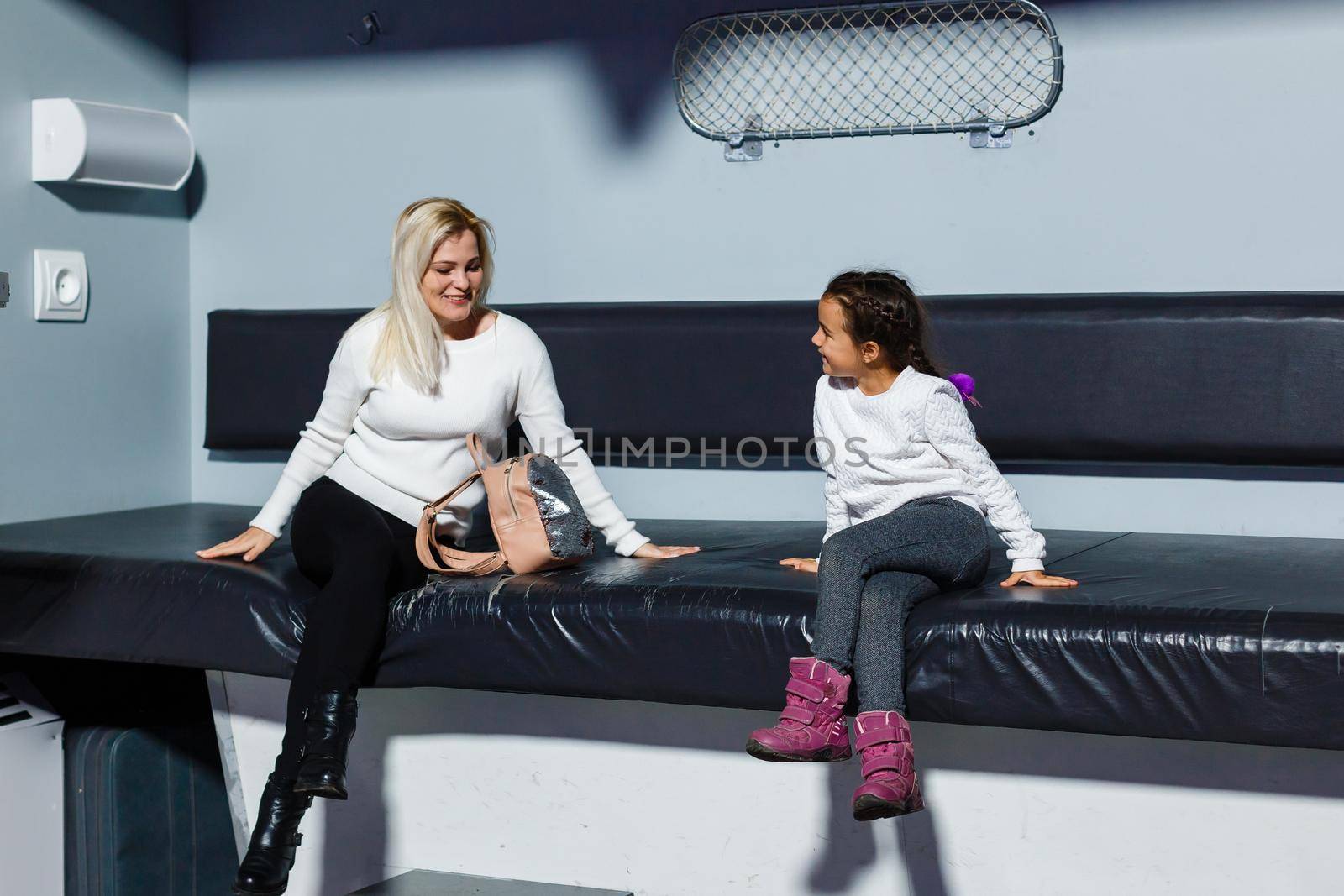 Ukraine, Kiev - February 2, 2020: Interior of exhibition ukraine wow. mother and daughter on the big train seat by Andelov13