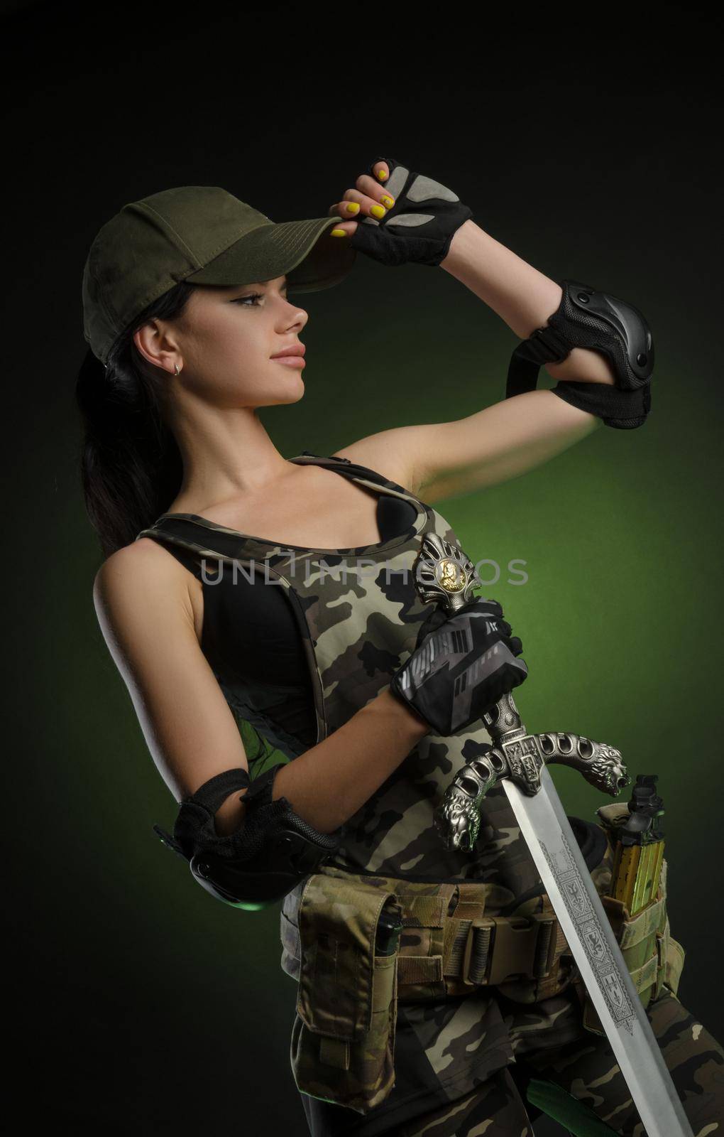 the girl in military special clothes posing with a gun in his hands on a dark background in the haze by Rotozey