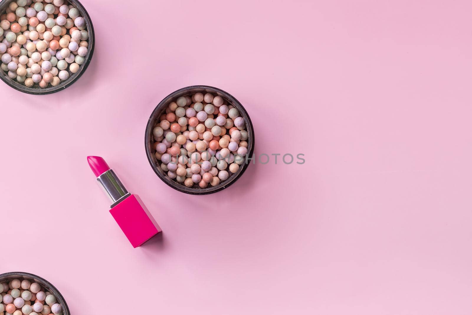 Decorative cosmetics and accessories for makeup on grey background