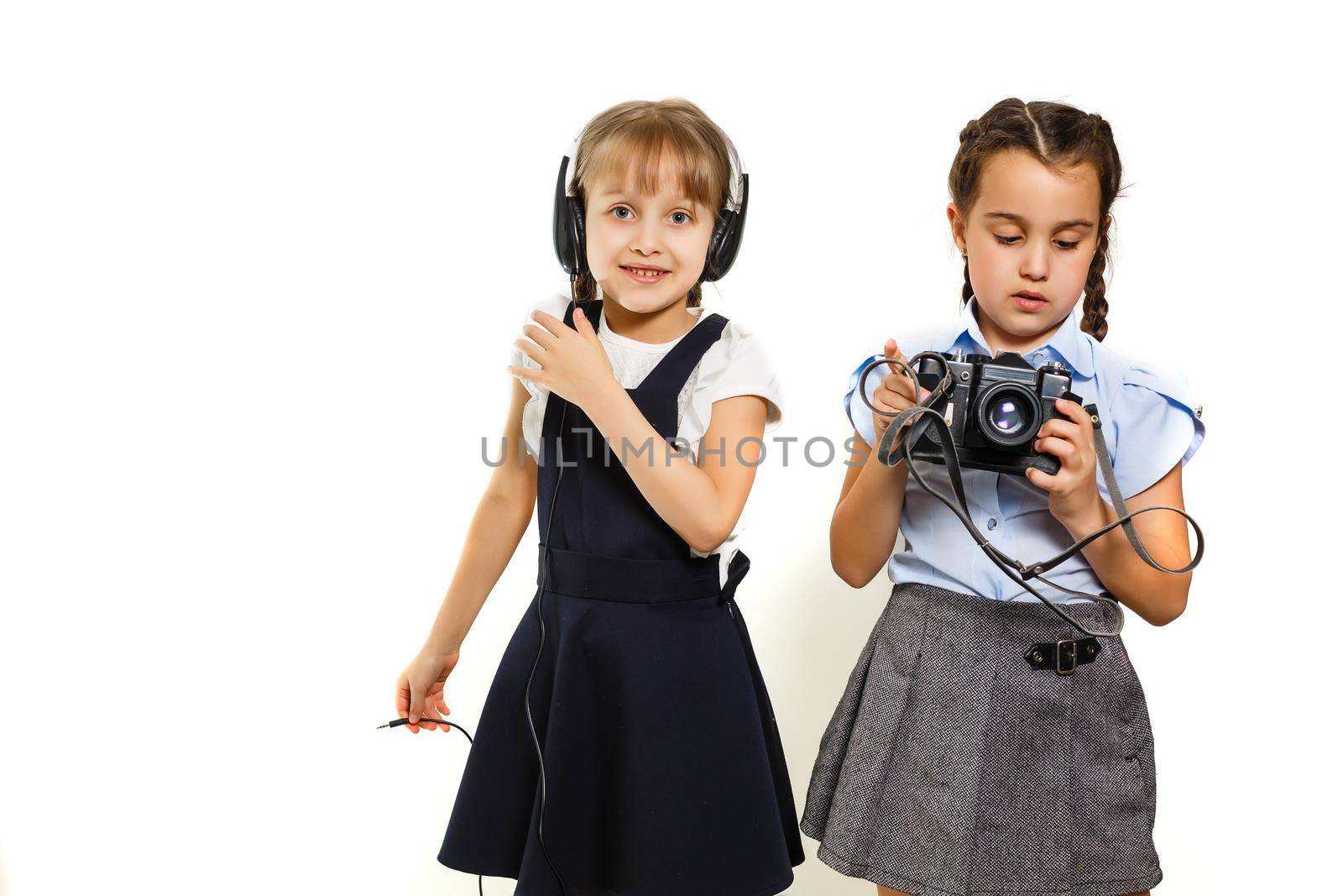 Two little schoolgirls. Education, fashion, friendship concept.