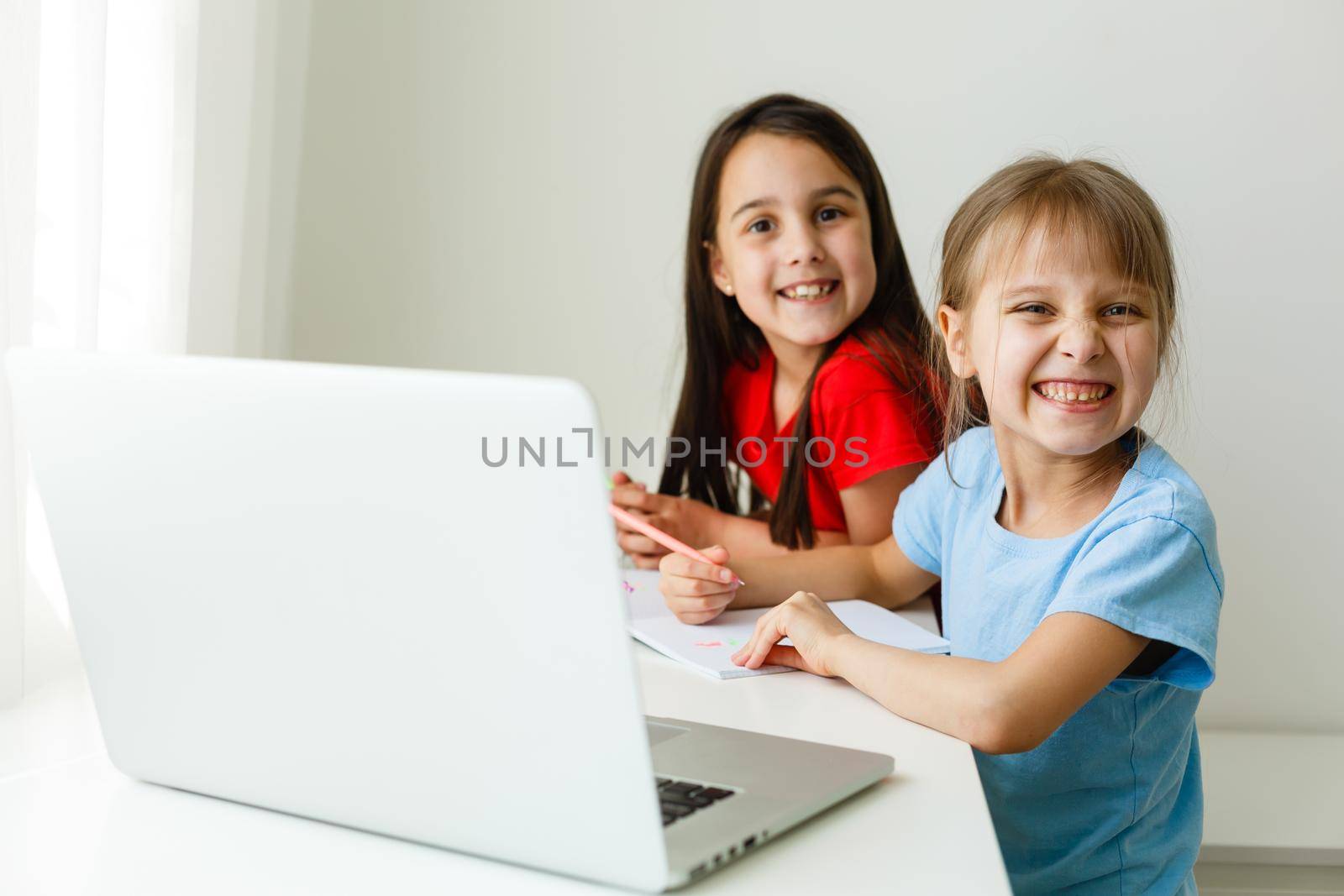 Pretty stylish schoolgirls studying math during her online lesson at home, social distance during quarantine, self-isolation, online education concept