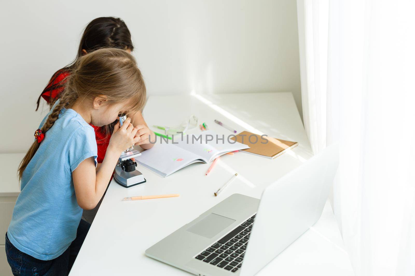 Learning from home, Home school kid concept. Little children study online learning from home with laptop. Quarantine and Social distancing concept.
