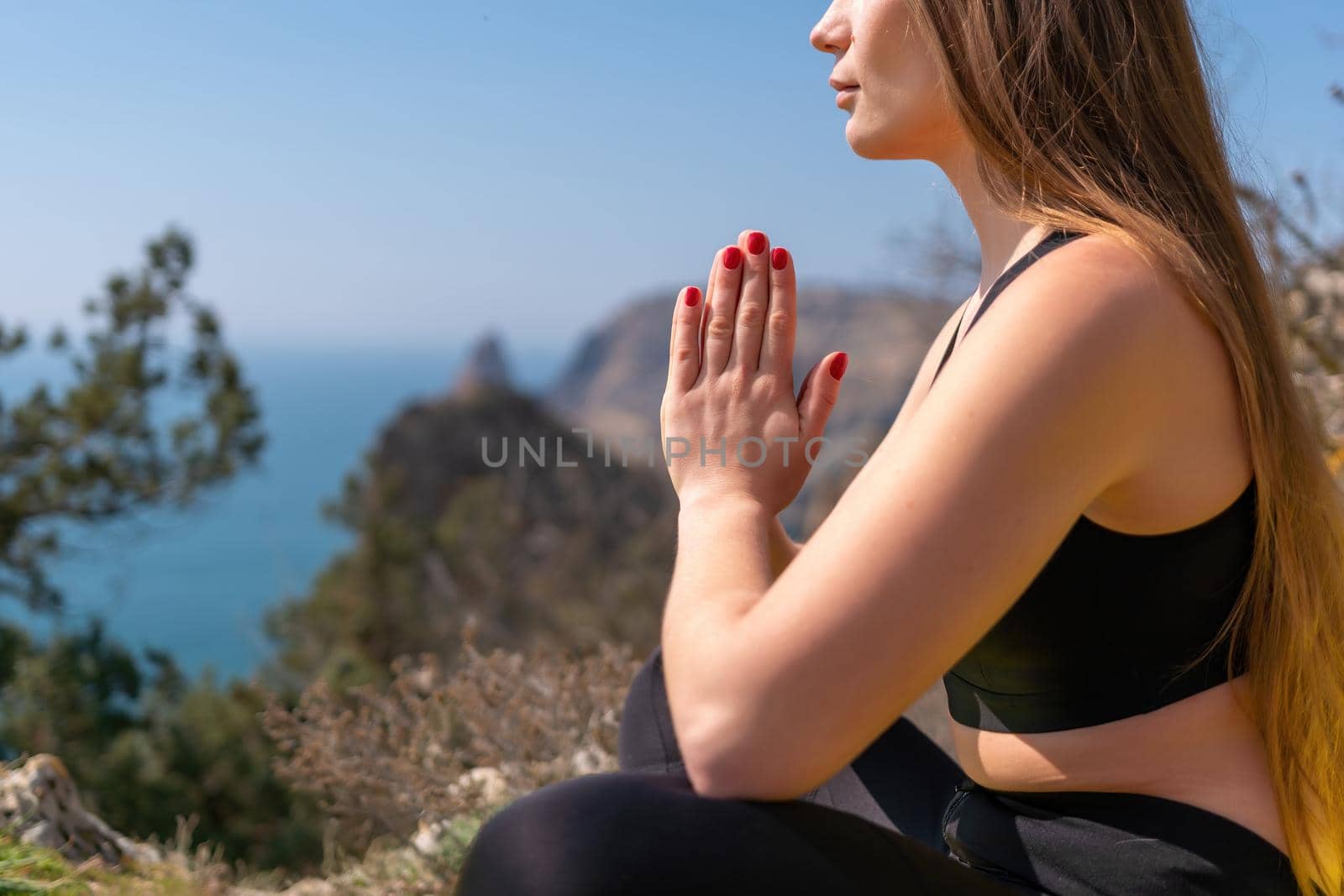 Group of young womans fitness instructor in Sportswear Leggings and Tops, stretching in the gym before pilates, on a yoga mat near the large window on a sunny day, female fitness yoga routine concept.
