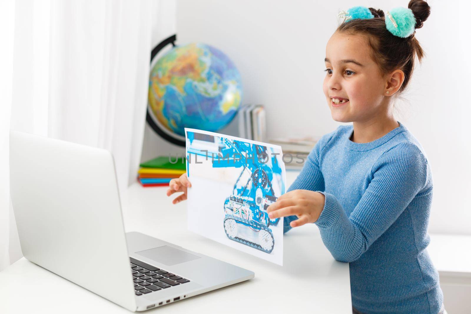 Online distance learning at home during quarantine. little girl learns logic on laptop online