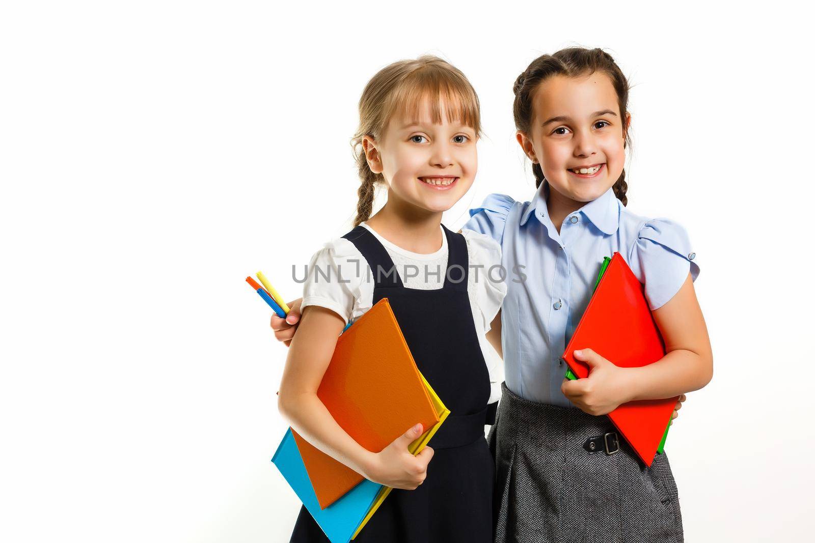 Two little schoolgirls. Education, fashion, friendship concept.