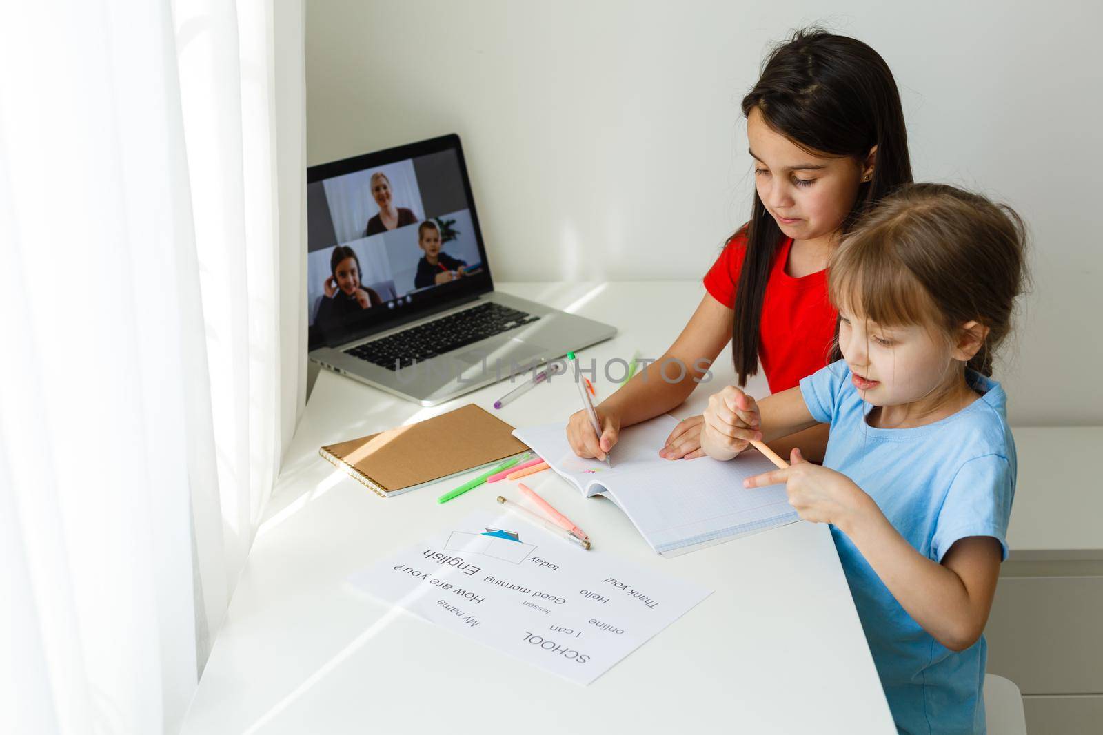 Pretty stylish schoolgirls studying math during her online lesson at home, social distance during quarantine, self-isolation, online education concept