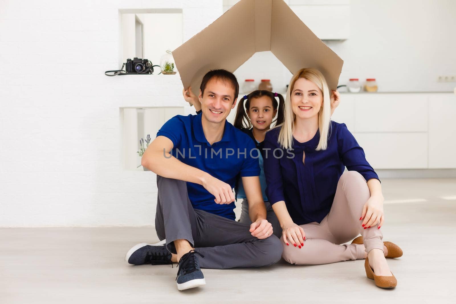 concept housing a young family. Mother father and child in new house with a roof