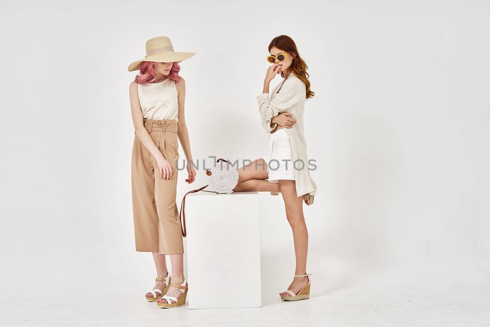 two girlfriends stand side by side fashion clothing glamor posing by Vichizh