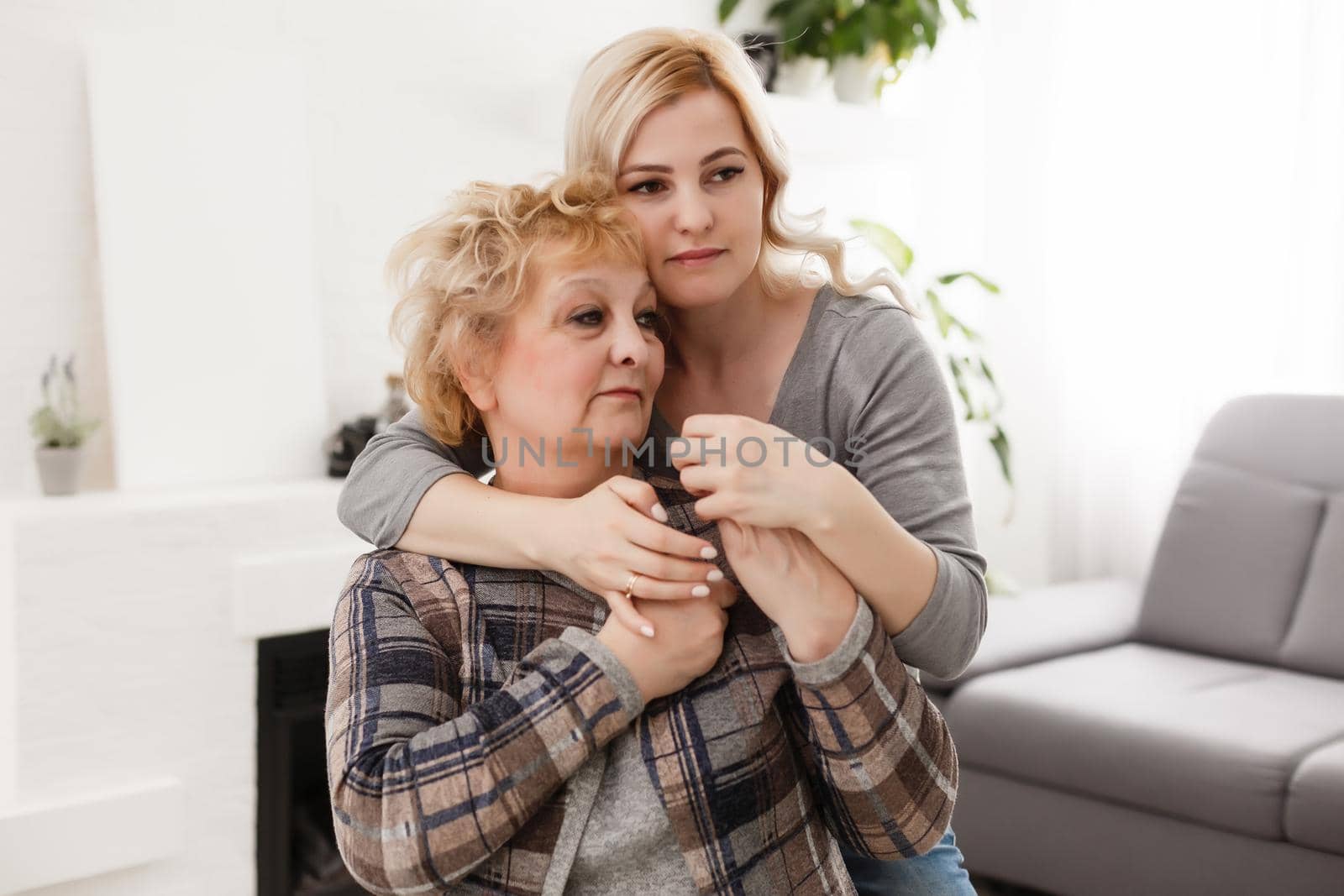 happy senior mother and adult daughter closeup portrait at home