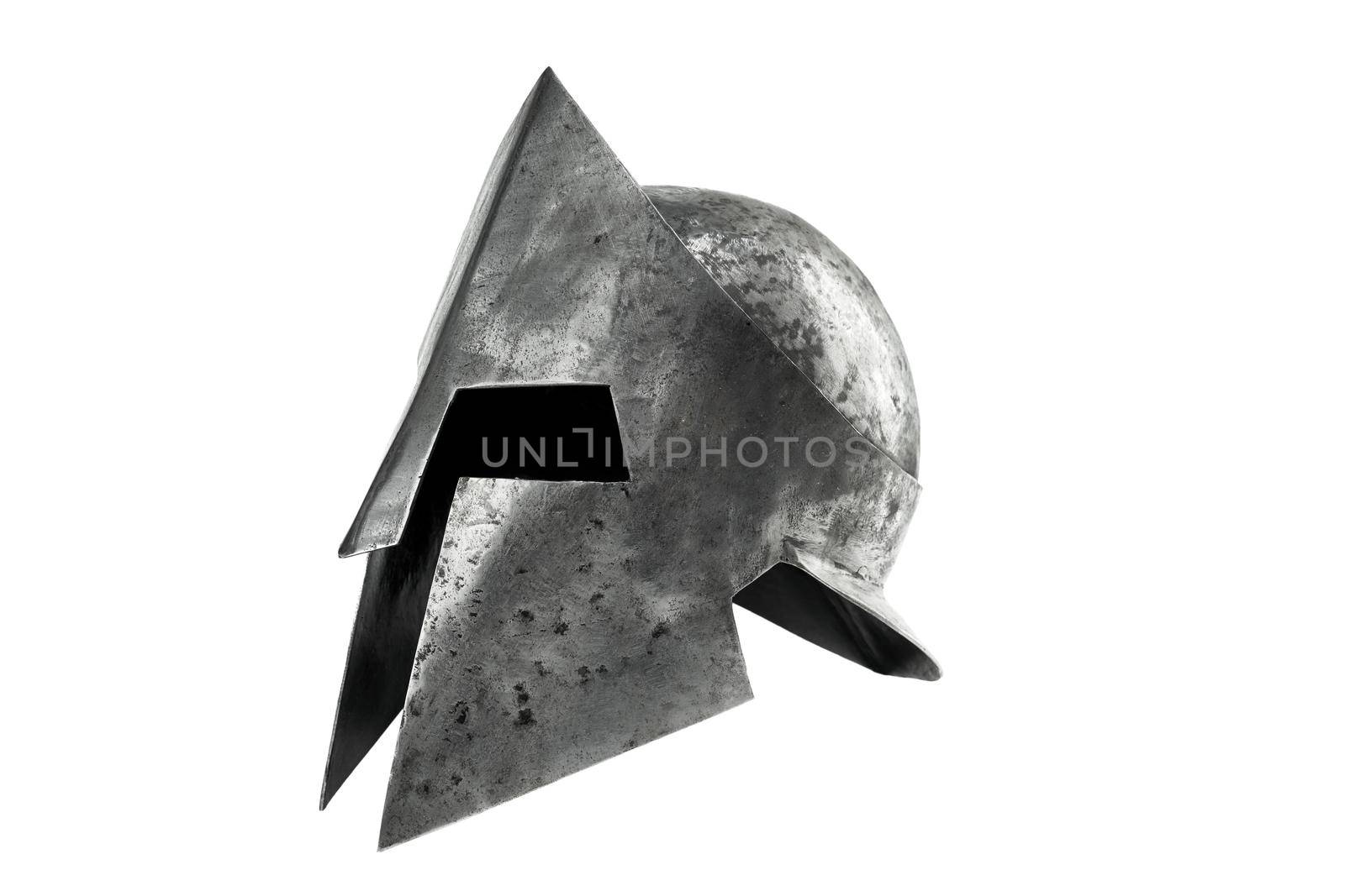 Side view of ancient metal tough spartan helmet isolated on white studio background. Medieval armor, archeological souvenir from past, iron head antique protection.