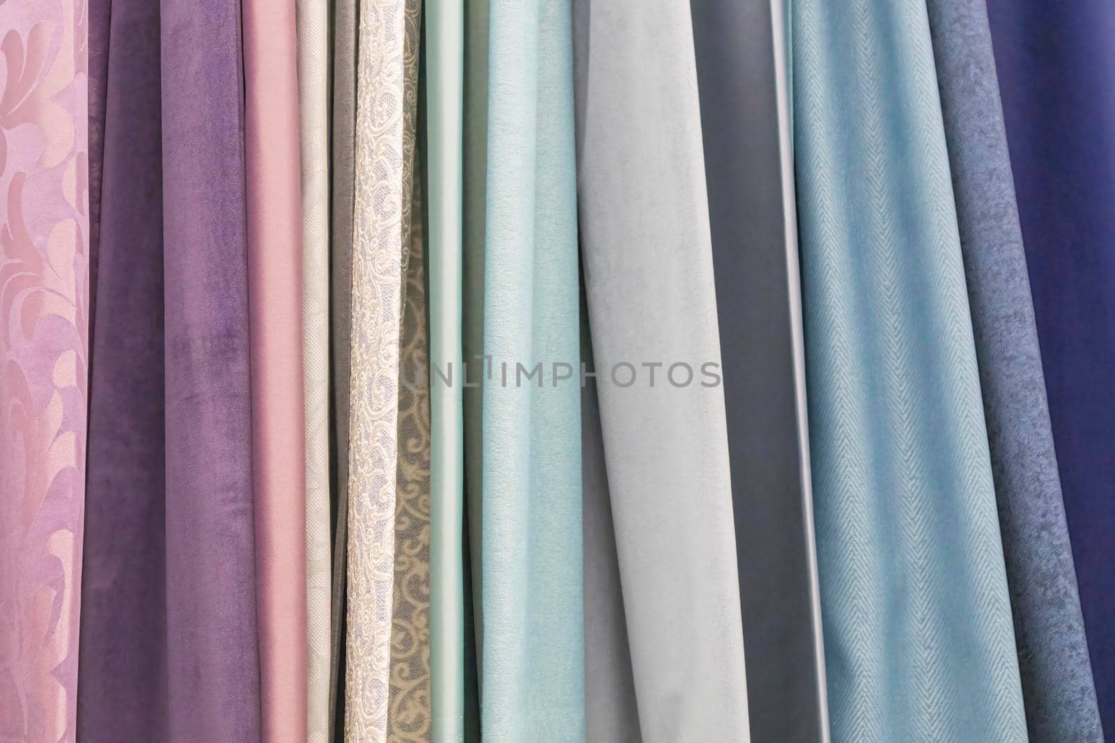 multicolored textures of fabrics on the shelves of stores close-up. High quality photo