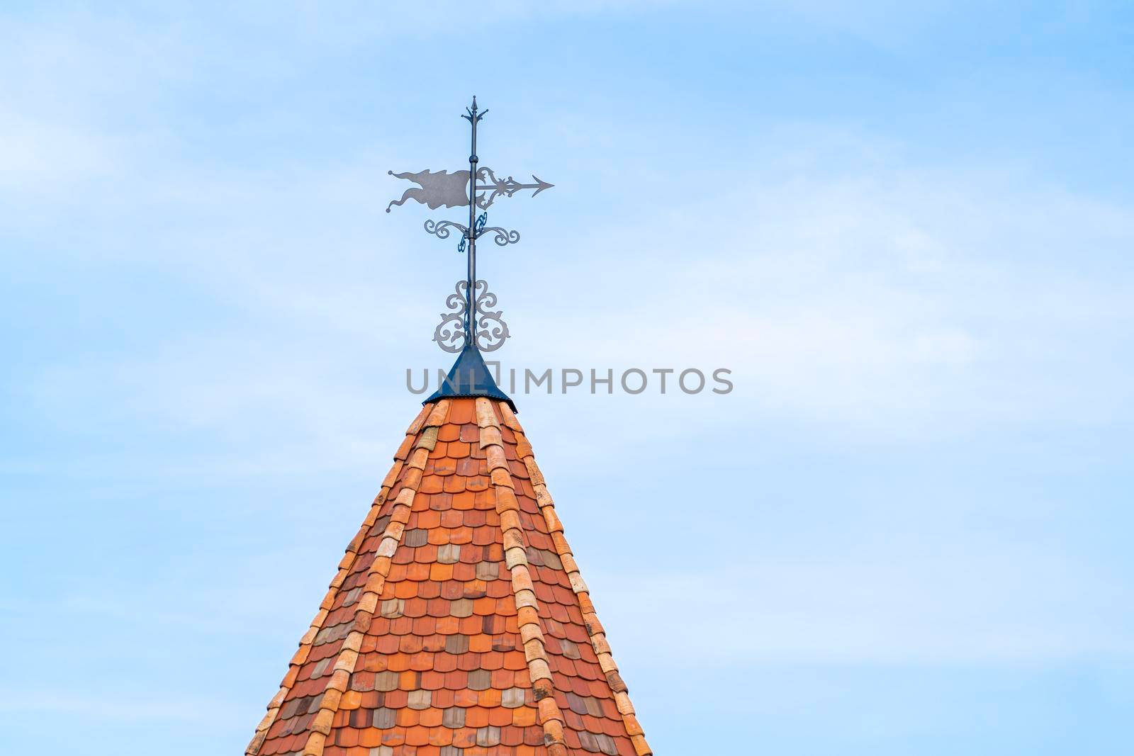 the tower of an old castle with a weather vane. High quality photo