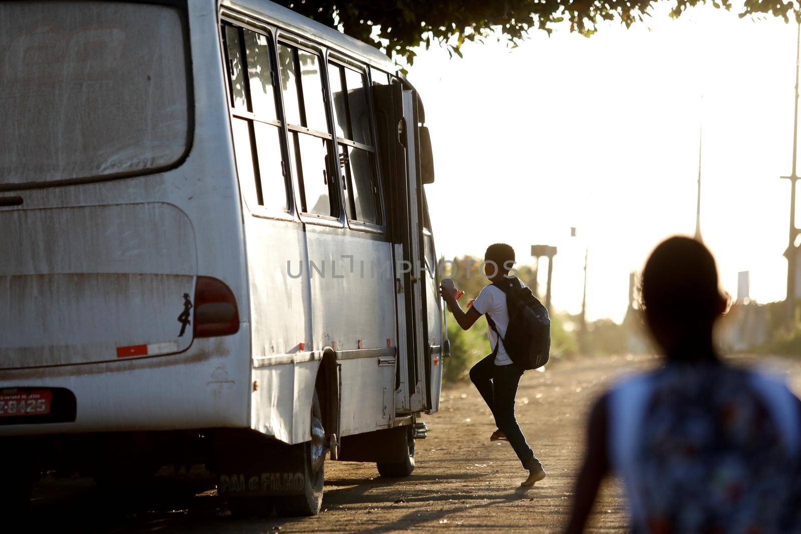 santo antonio de jesus, bahia, brazil - august 7, 2019: public school students are seen along the school transport bus in the street area in the city of Santo Antonio de Jesus.
