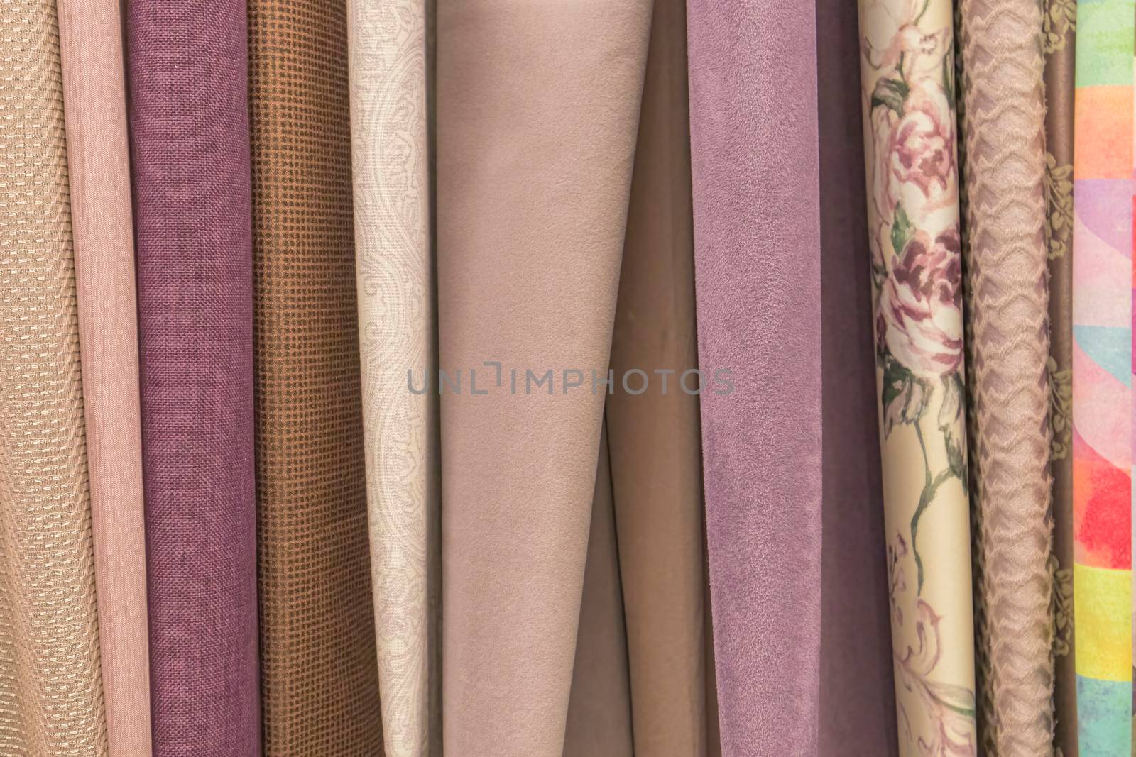 multicolored textures of fabrics on the shelves of stores close-up. High quality photo