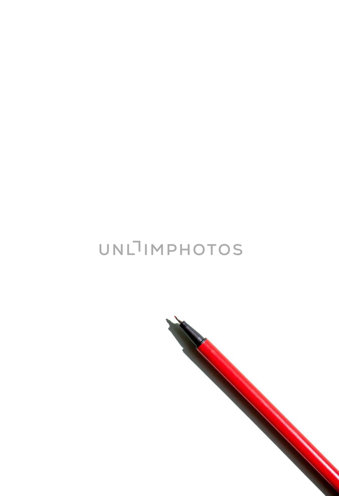 the red pen is ready to write text on a white background.  by AnatoliiFoto