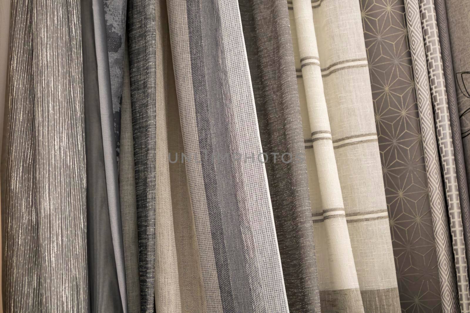 multicolored textures of fabrics on the shelves of stores close-up. High quality photo