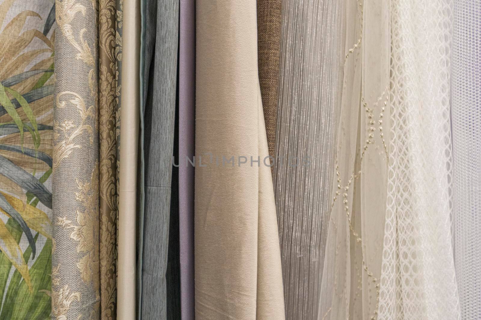multicolored textures of fabrics on the shelves of stores close-up. High quality photo
