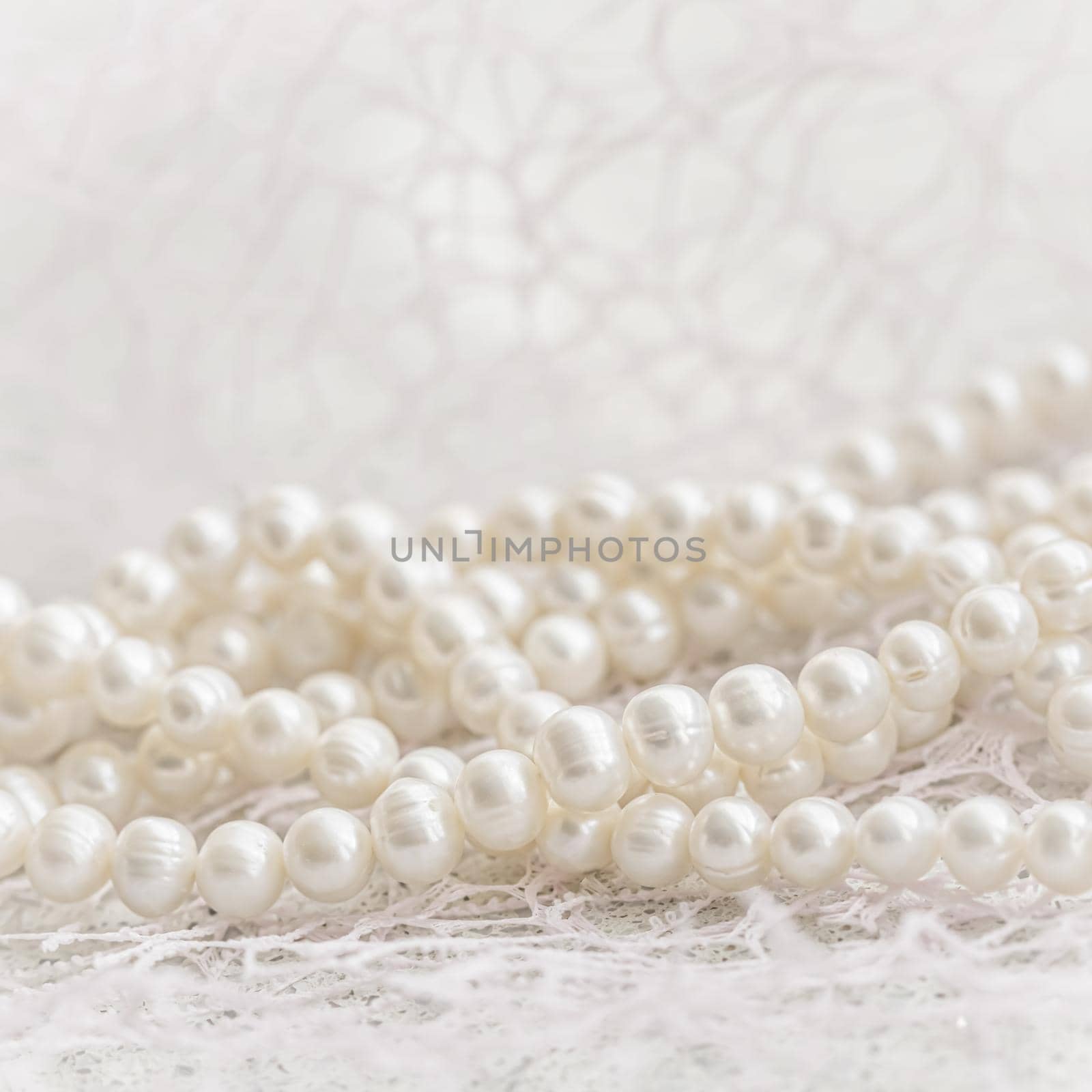 Nature white string of pearls in soft focus, with highlights by Olayola