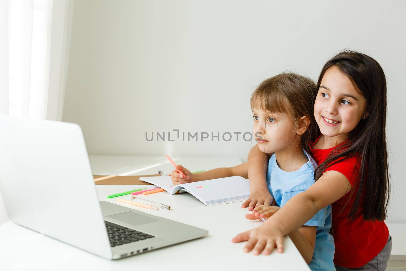 Pretty stylish schoolgirls studying math during her online lesson at home, social distance during quarantine, self-isolation, online education concept