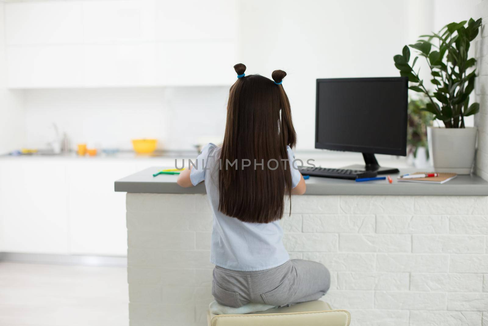 Pretty stylish schoolgirl studying homework math during her online lesson at home, social distance during quarantine, self-isolation, online education concept, home schooler by Andelov13