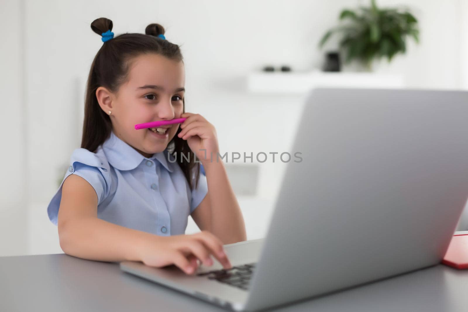 little girl studying with laptop online learning