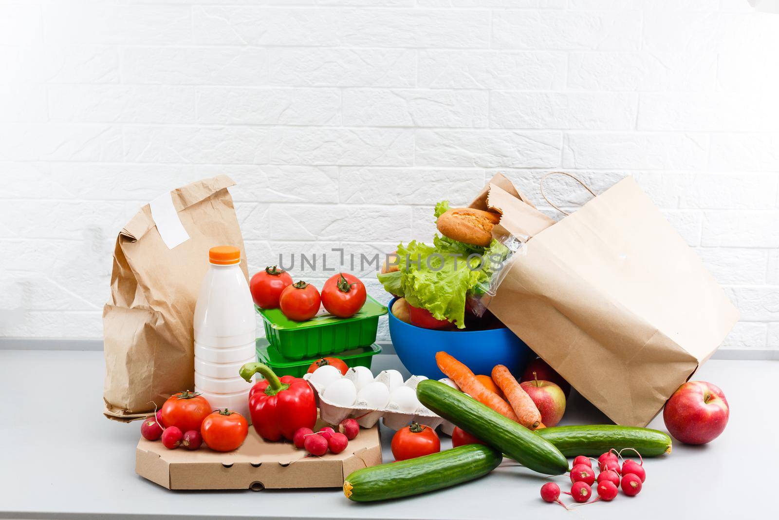 Different set of products to order in paper bags on white background