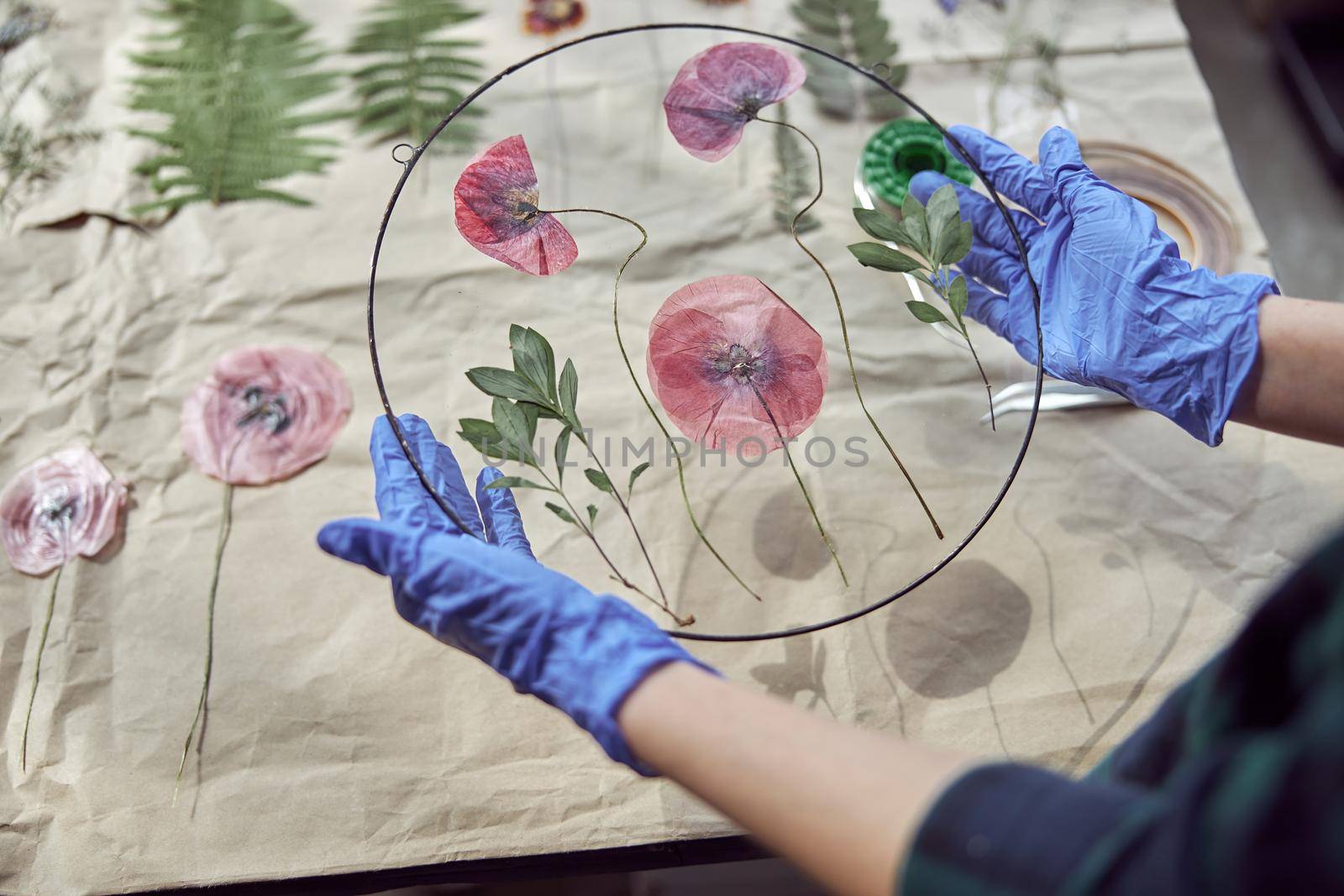 Confident female florist is working with dryed flowers in cozy flower shop