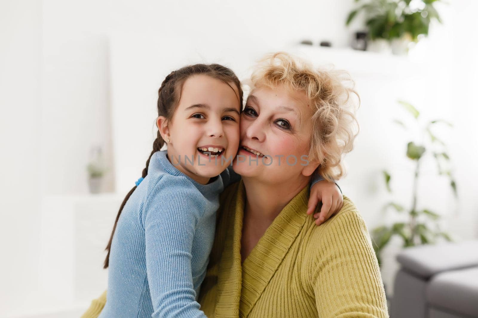 Grandmother and granddaughter portrait, embraced